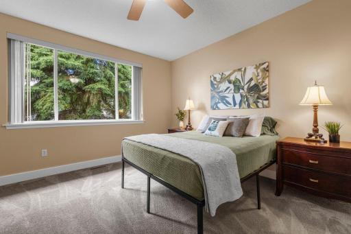 The huge window in the primary bedroom creates a bright and inviting space