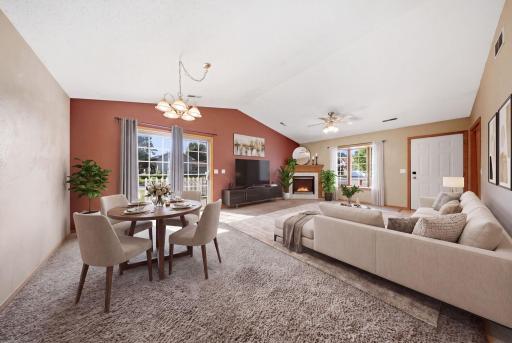 The welcoming living room is anchored by a cozy fireplace and features a charming bay window. (virtually staged)