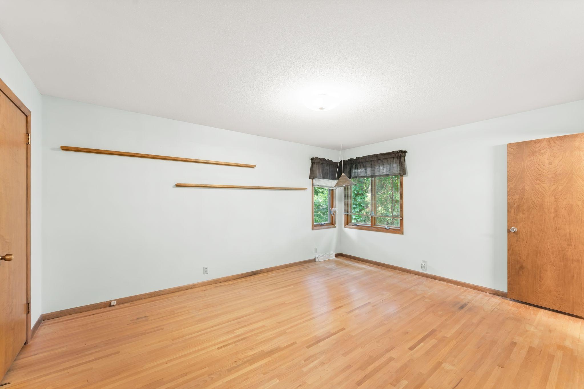 The carpet has been removed from the Primary bedroom to show the beautiful hardwood floors that have been covered up in this room, as well as in all the main floor carpeted areas since the house was built.