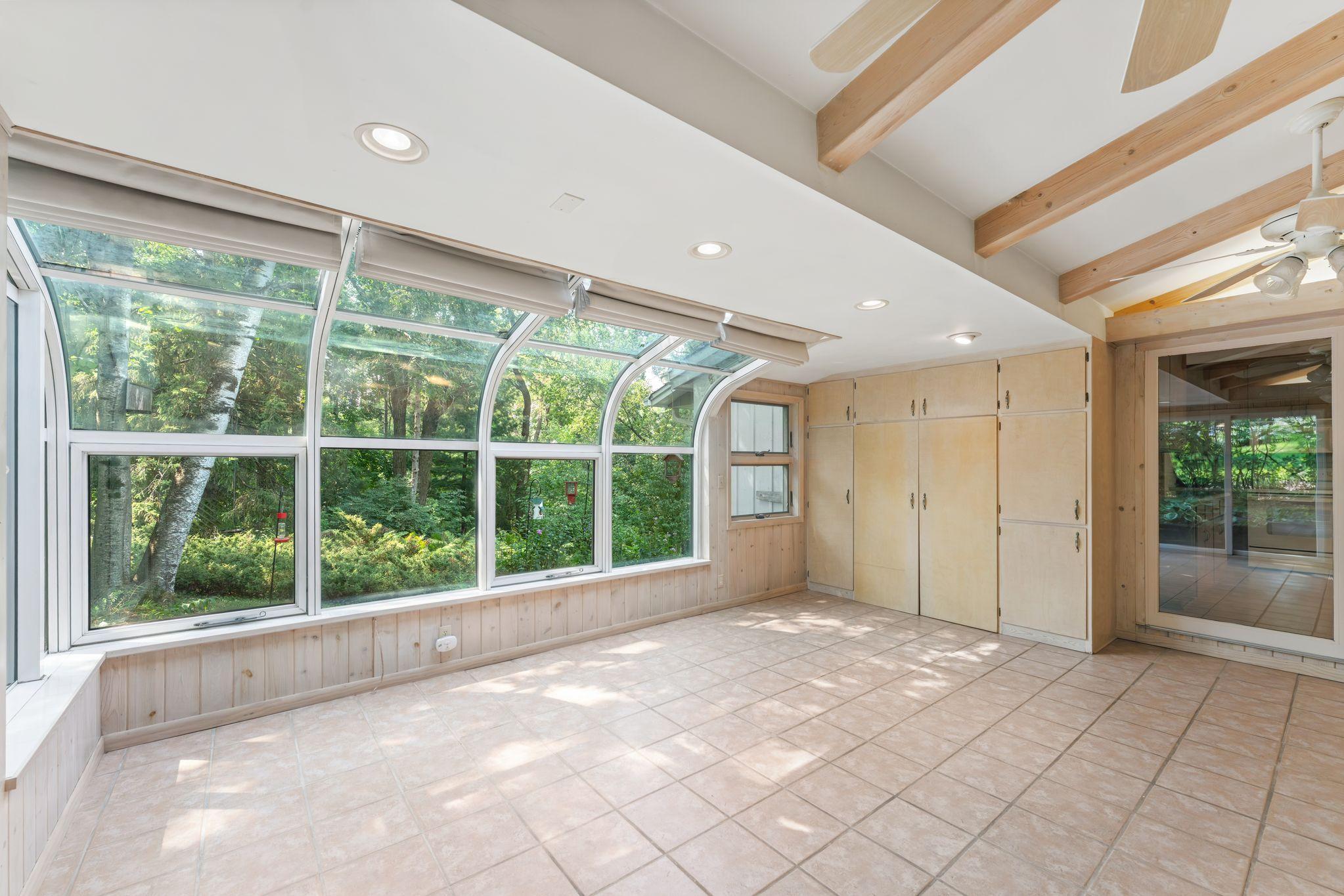 A wall of cabinets for storage in the solarium