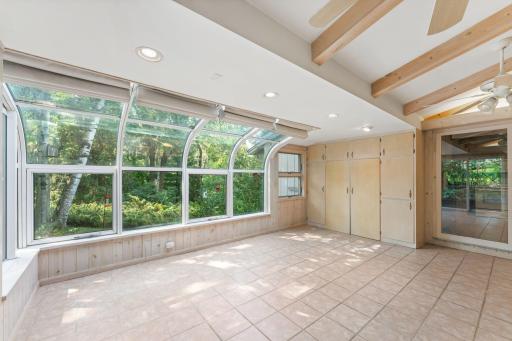 A wall of cabinets for storage in the solarium