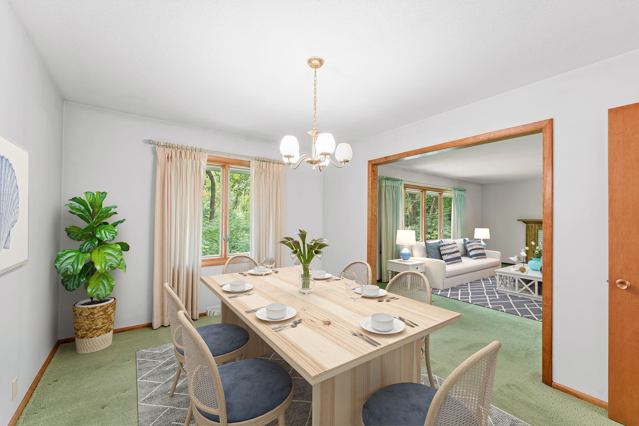 The virtually staged dining room opens up into the spacious living room
