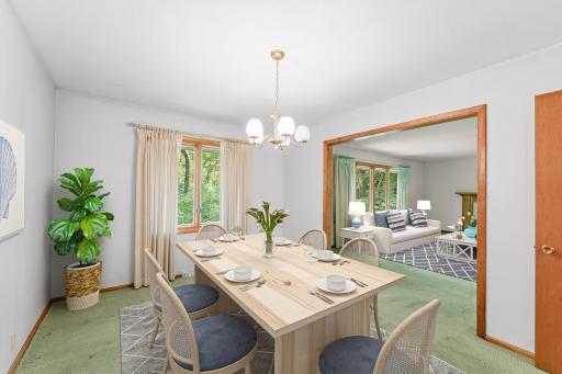 The virtually staged dining room opens up into the spacious living room