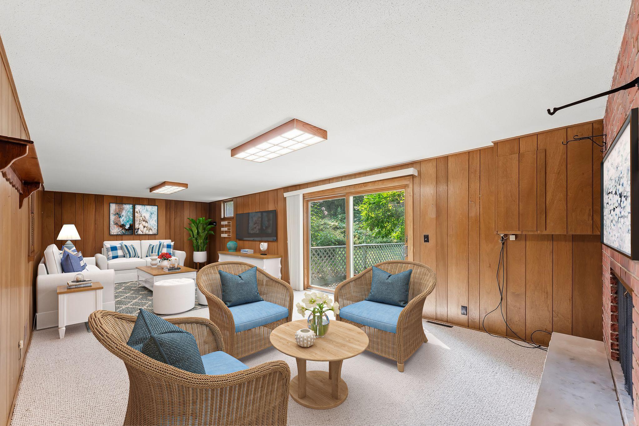 Virtually staged lower level family room with a cozy seating arrangement perfectly arranged to enjoy the 2nd fireplace in the home
