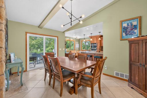 Large tiled dining space with modern lighting