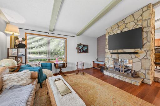Double sided woodburning fireplace between the living room and dining room