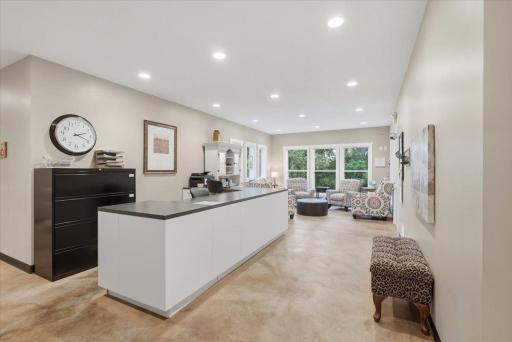 A spacious lobby space with waiting area, large front desk and beautiful windows