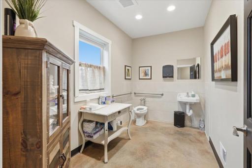 A spacious restroom at the end of the hall for guests, clients, etc.