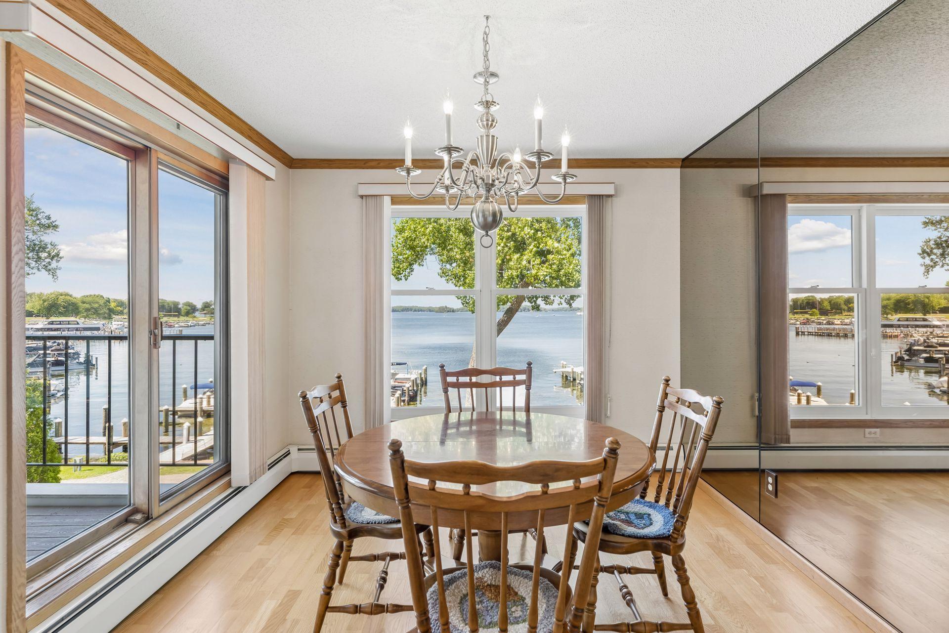 Dinette with big floor to ceiling windows and patio door to the balcony