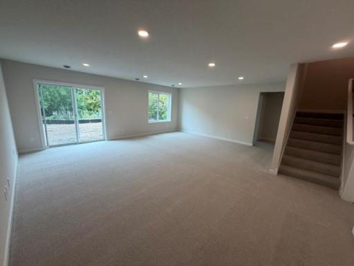 Finished lower level features 5th bedroom, another bathroom, and with walkout patio door to large backyard, landscaping, irrigation, sod and Trees to come