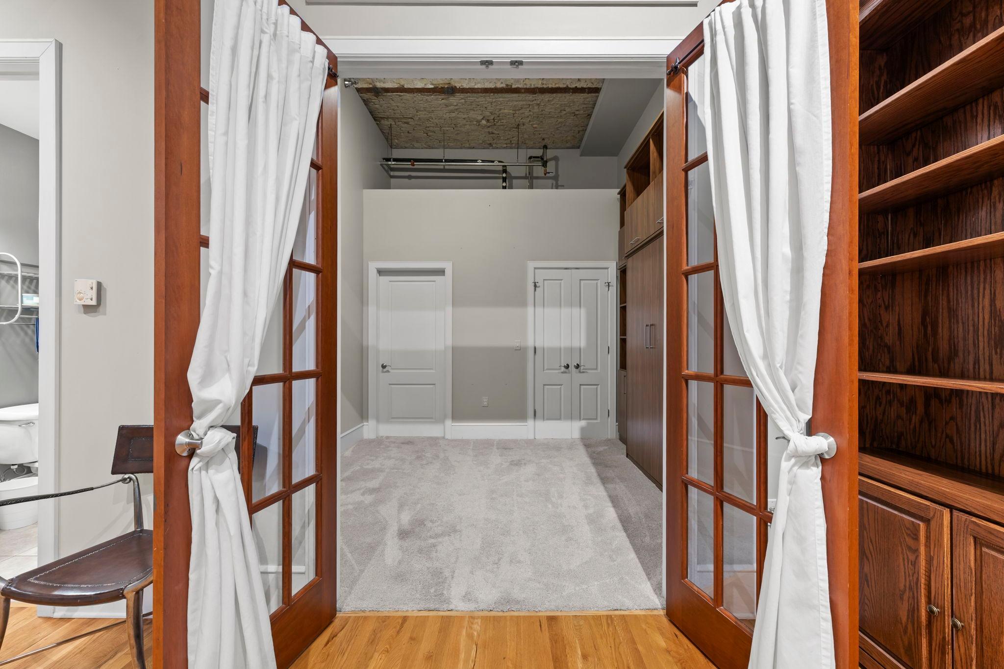 French doors lead to second bedroom or office.