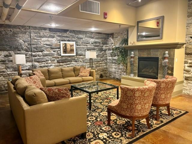 Community room in the lower level with cozy fireplace.