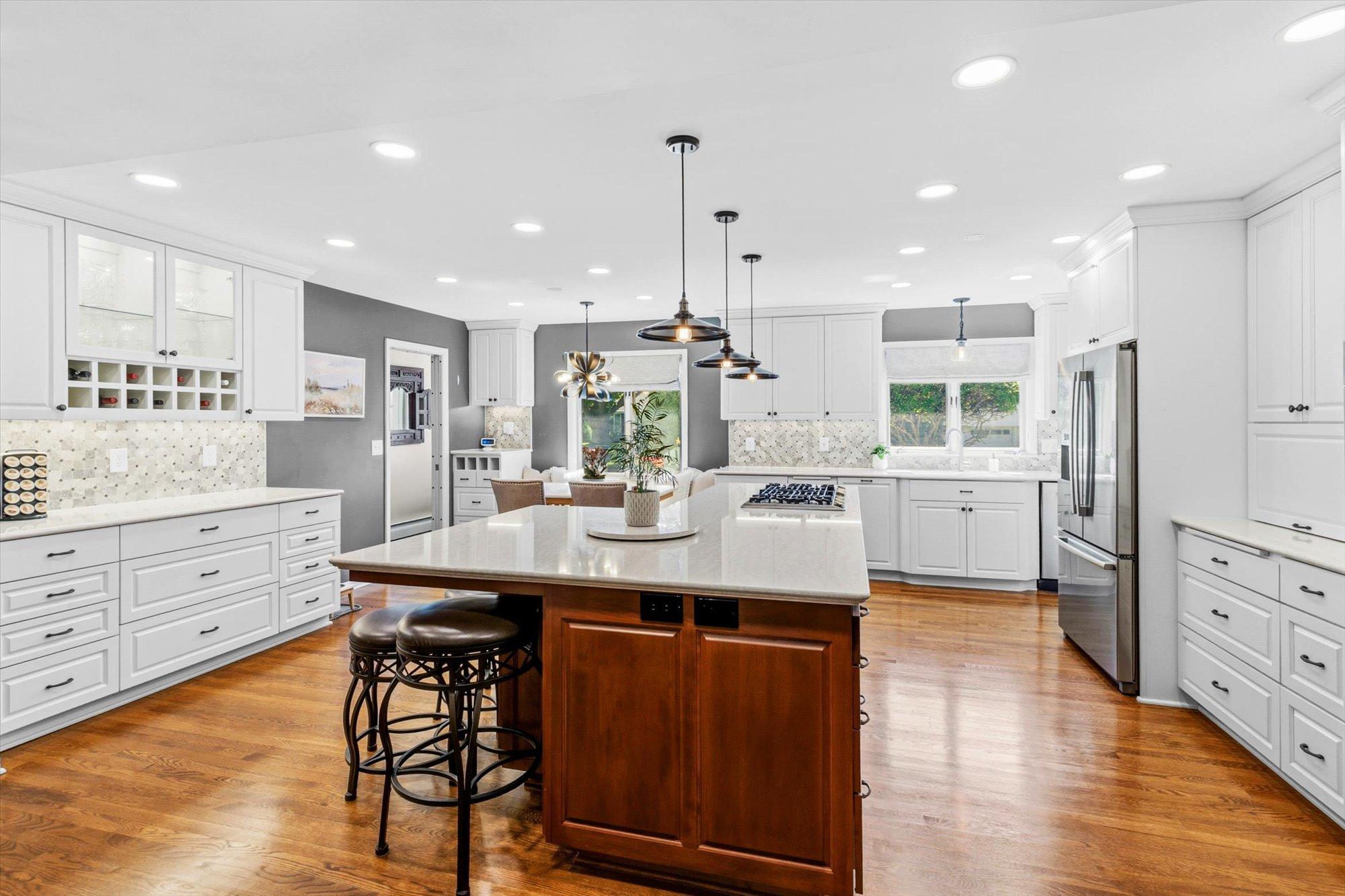 A gourmet's dream. Custom cabinetry, designer back splash, solid surface countertops, stainless steel appliances, all atop the gleaming hard wood floors.
