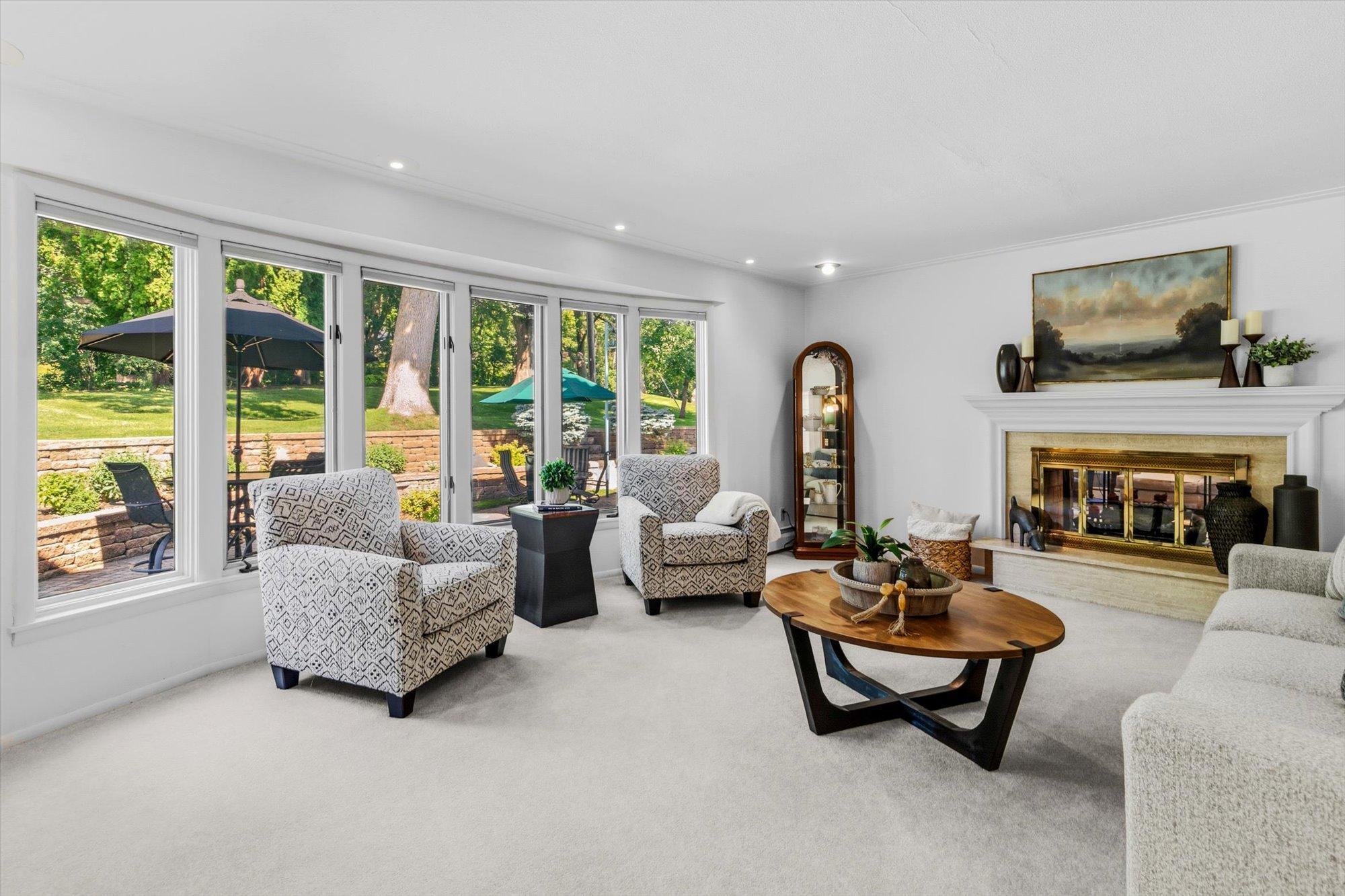 The main level boasts both formal and informal living spaces. Main Level Ling room - complete with dual sided, wood burning fireplace.