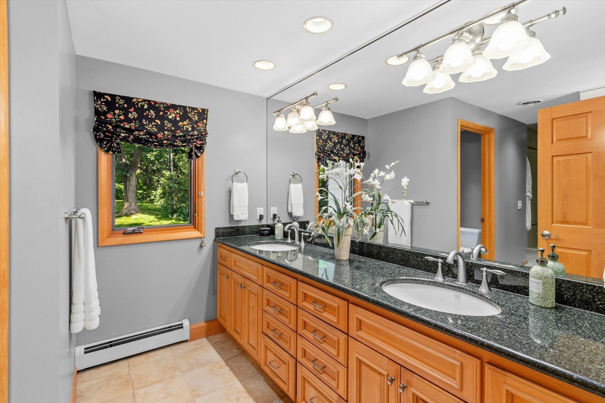 Primary bath, featuring dual vanities, and a large walk-in shower.