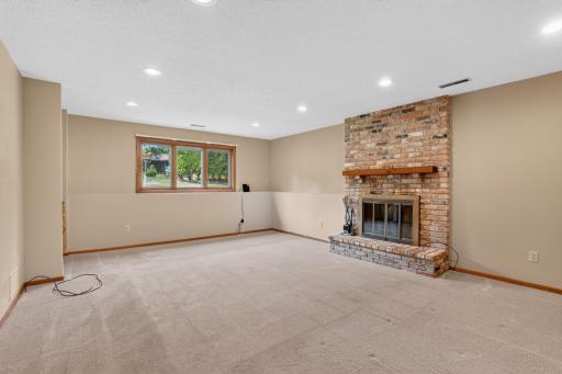 Lower level family room with wood burning fireplace