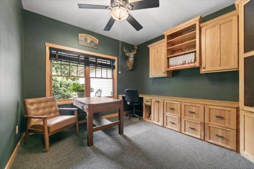 Executive-Style Office where working from home never looked more professional. Glass door, rich colors, hickory built-in cabinets, filing drawers, shelves & gun display. In-home meetings easily held in this space or on the front porch.