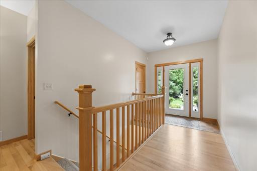 Welcoming foyer with full glass front door with side panels for exceptional natural light. Freshly painted main level. Pay attention to thoughtful tilework.