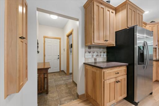 Tiled entry from garage leads into convenient mudroom/laundry on the main level. Notice well-placed fold-down ironing board... converse or watch TV while finishing laundry.