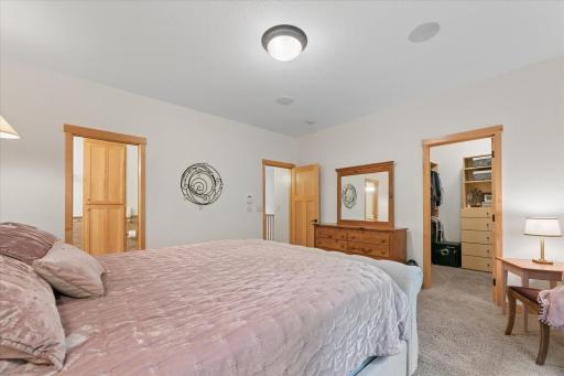 Romantic oversized primary suite with room for king-size furniture. Featuring 9' ceilings, surround sound music speakers, reading sconces, views of wooded backyard, walk-in closet and private, full-bathroom. Bedroom is located on main level.
