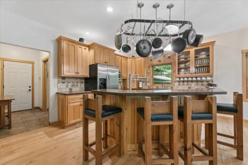 Casual 4-place seating at bar-height countertop. Split counter heights of center island hides meal-prep messes.