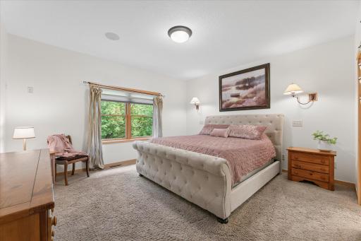 Romantic oversized primary suite with room for king-size furniture. Featuring 9' ceilings, surround sound music speakers, reading sconces, views of wooded backyard, walk-in closet and private, full-bathroom. Bedroom is located on main level.