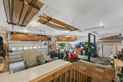 Oversized, attached garage feels more like an amazing workshop. Workbenches, storage cabinets, shelves, overhead lumber racks, and attic storage.