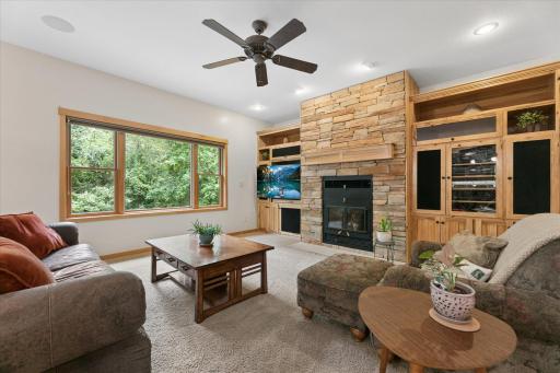 Kozy Heat - Wood-burning fireplace with floor to ceiling stacked, true stone surround. Hickory mantle & built-in media cabinets & display shelves anchor this open floor plan. Honeywell thermostat & air-exchanger for perfect calculated comfort.