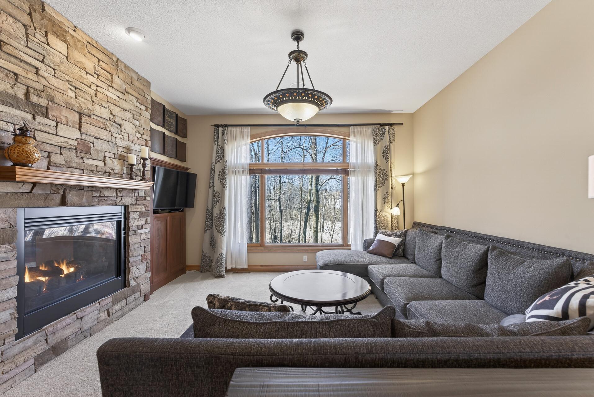Cozy meets elevated — anchored by a stunning stone fireplace
