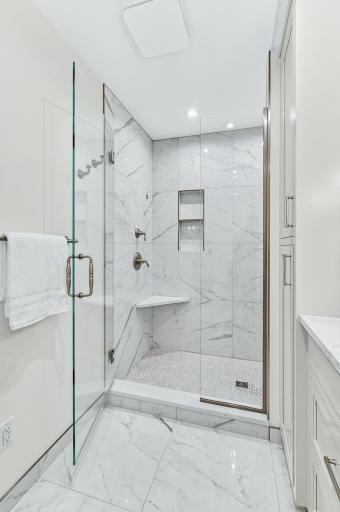 Glass enclosed marble walk-in shower