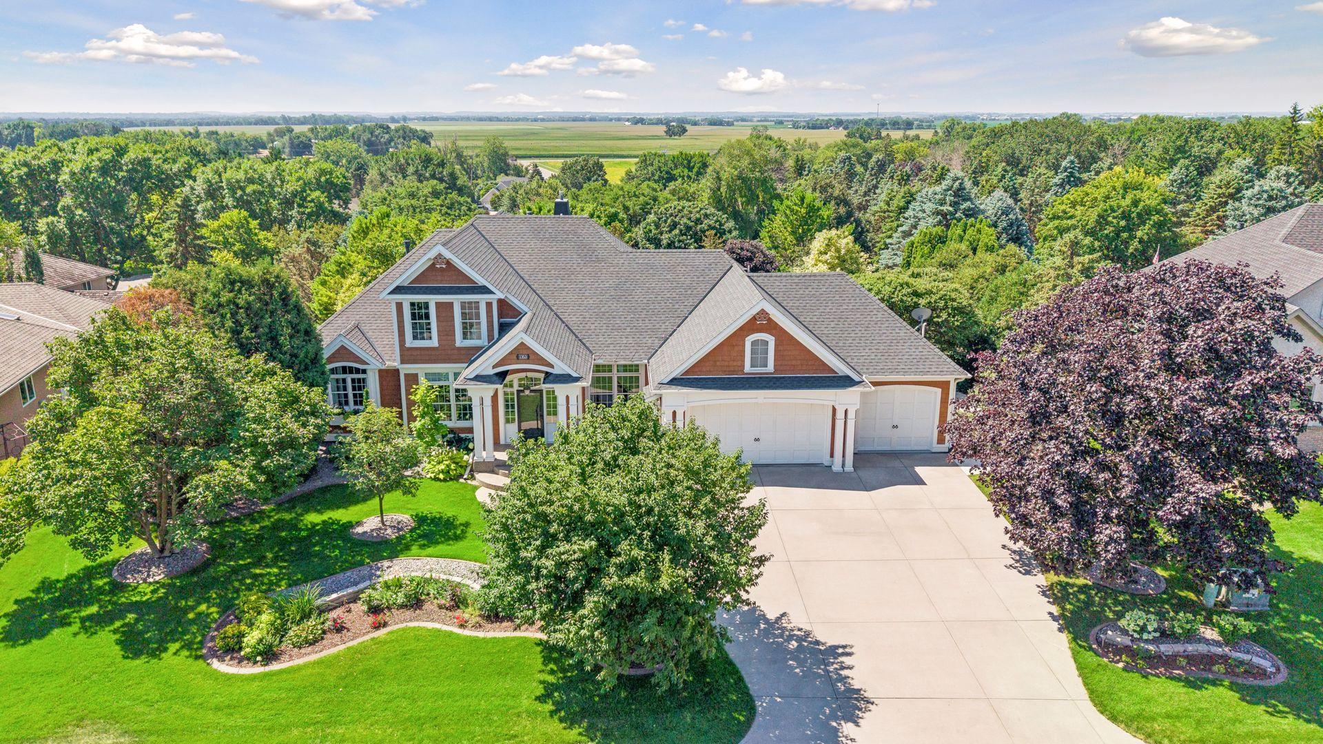 Beautifully positioned among mature trees in one of the area's most sought-after neighborhoods, this custom home offers exceptional privacy, professionally designed landscaping, and timeless curb appeal.
