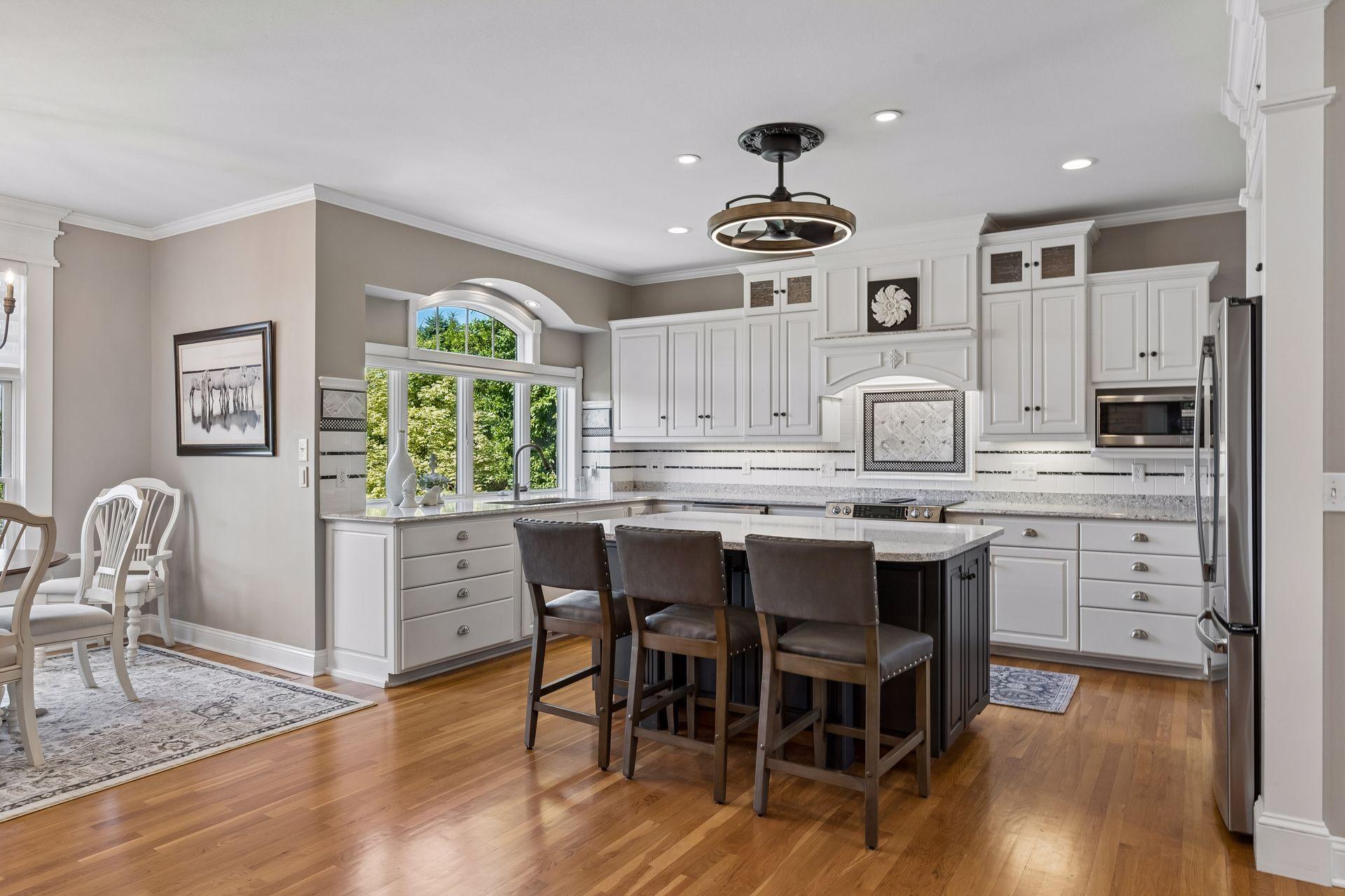 Gourmet Kitchen - Beautiful custom cabinetry, Quartz countertops, a large center island, abundant storage, and windows overlooking the gorgeous backyard.