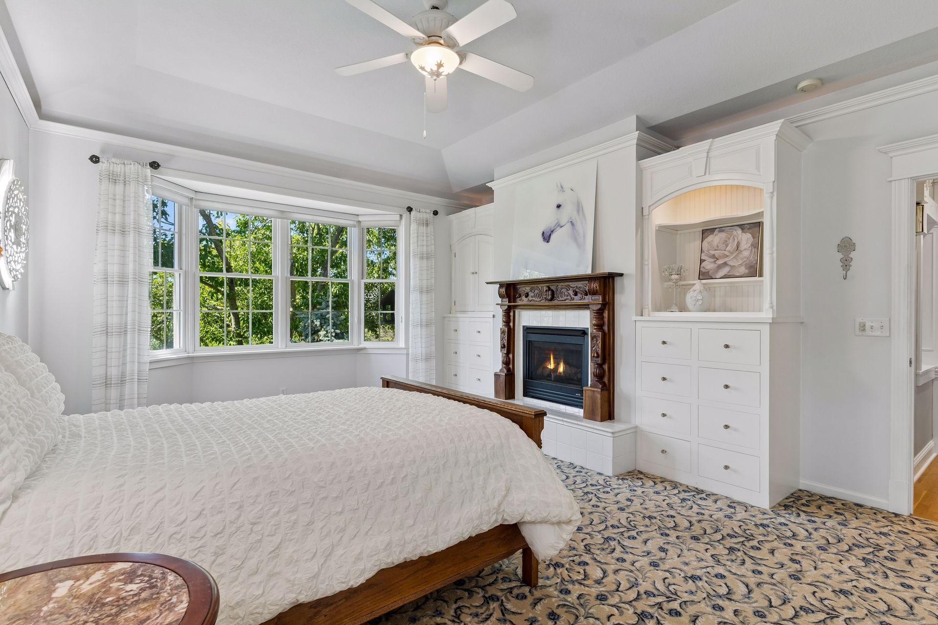 Designed for comfortable main-level living, the spacious Owner's Suite features custom built-ins, a Gas Fireplace with an antique mantel, and peaceful backyard views.