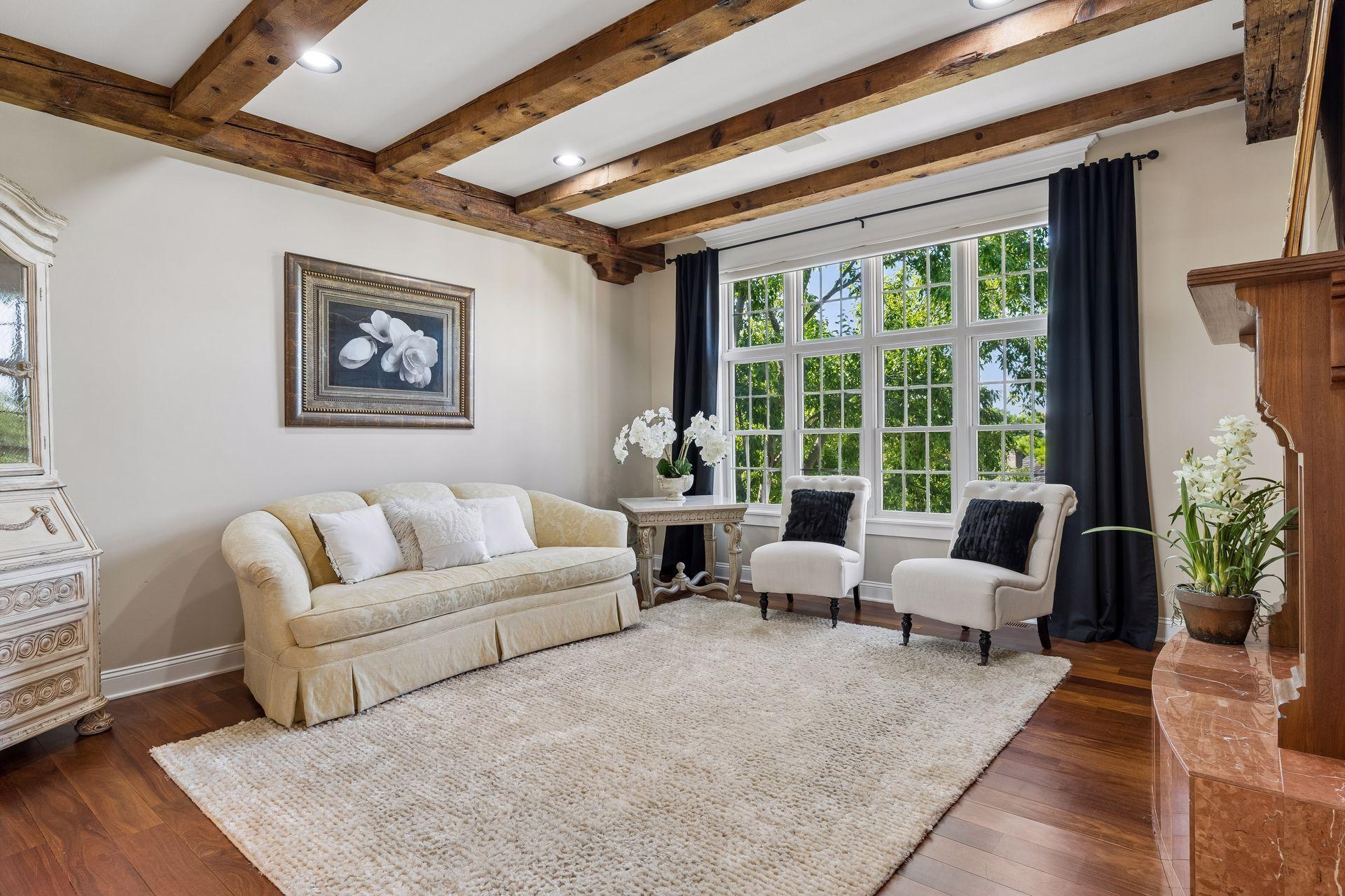 Great Room - Cherry hardwood floors, reclaimed barn beams, custom built-ins, and a stunning Gas Fireplace create a warm and welcoming centerpiece of the home.