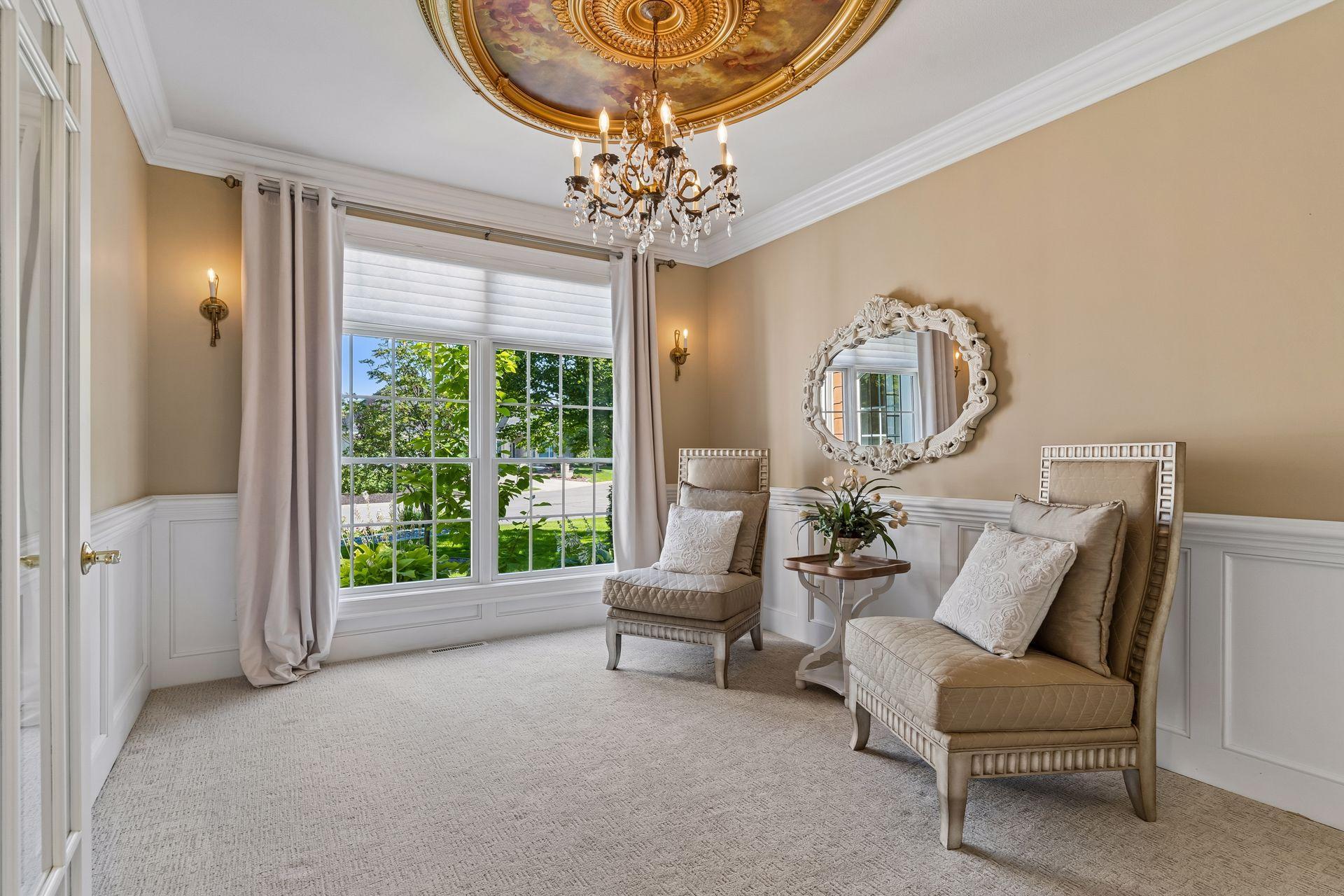Front Living Room features beautiful millwork, decorative wainscoting, and an impressive ceiling medallion to create a memorable setting for holidays and special occasions.