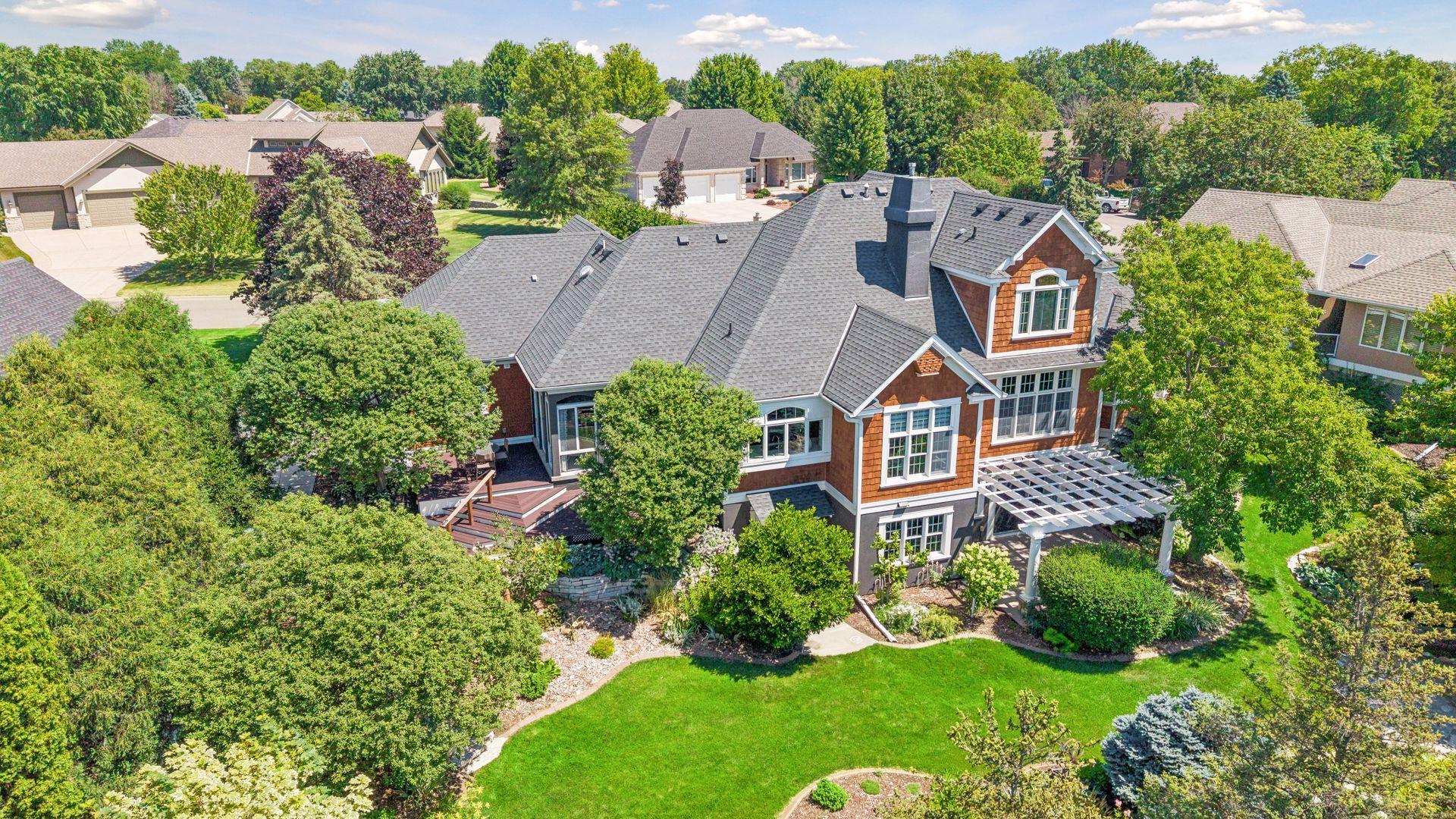 A spectacular aerial view showcases the home's beautifully designed outdoor living spaces, mature trees, and professionally landscaped grounds - creating a private retreat that's as impressive as the home itself.