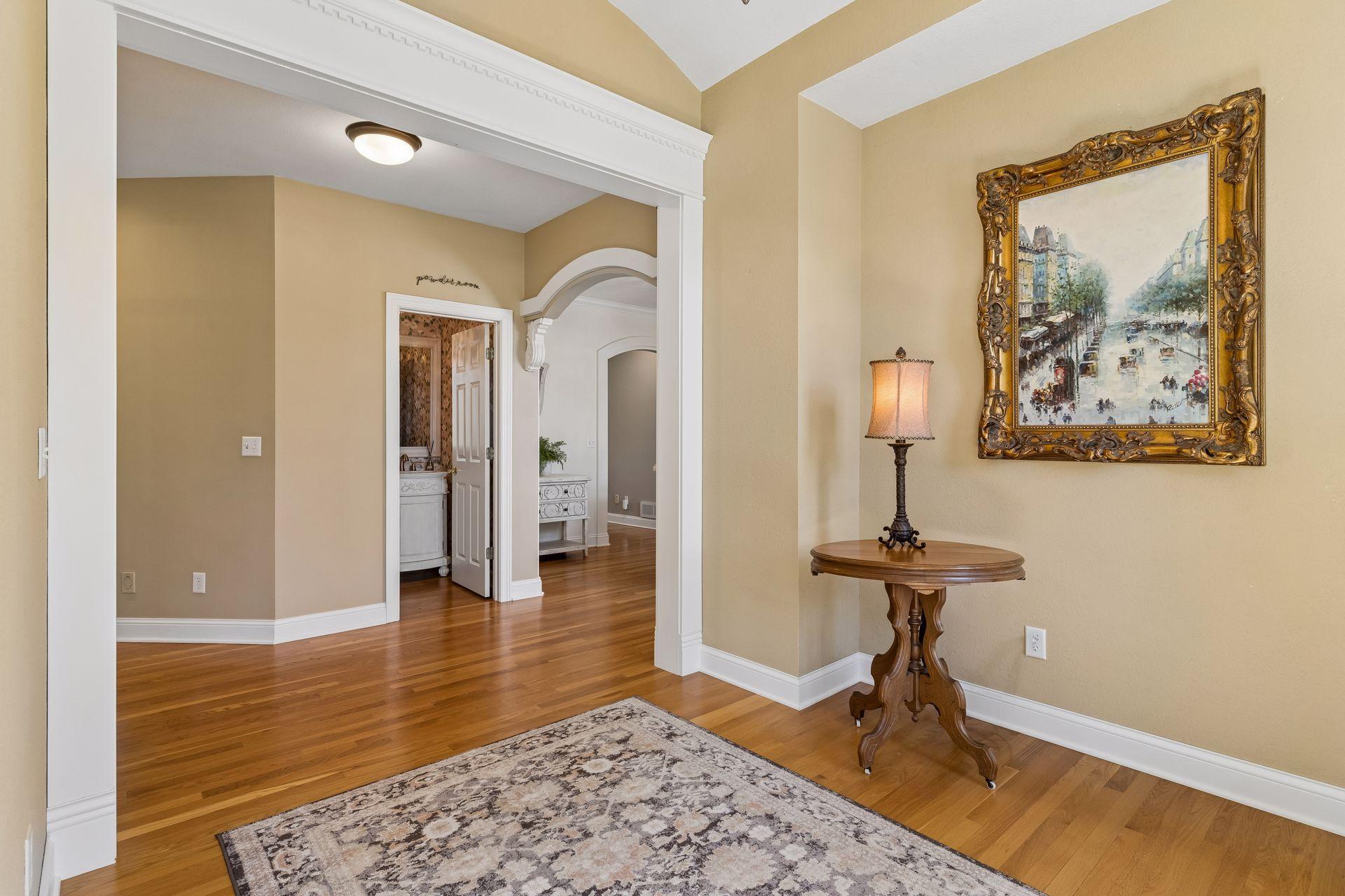 Decorative columns, graceful archways, and extensive crown molding create a warm, inviting transition into the main living spaces.