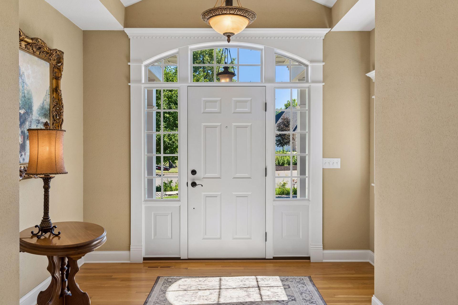 Step inside to a welcoming Foyer where abundant natural light, rich hardwood floors, detailed millwork, and elegant architectural finishes immediately set the tone for the home.