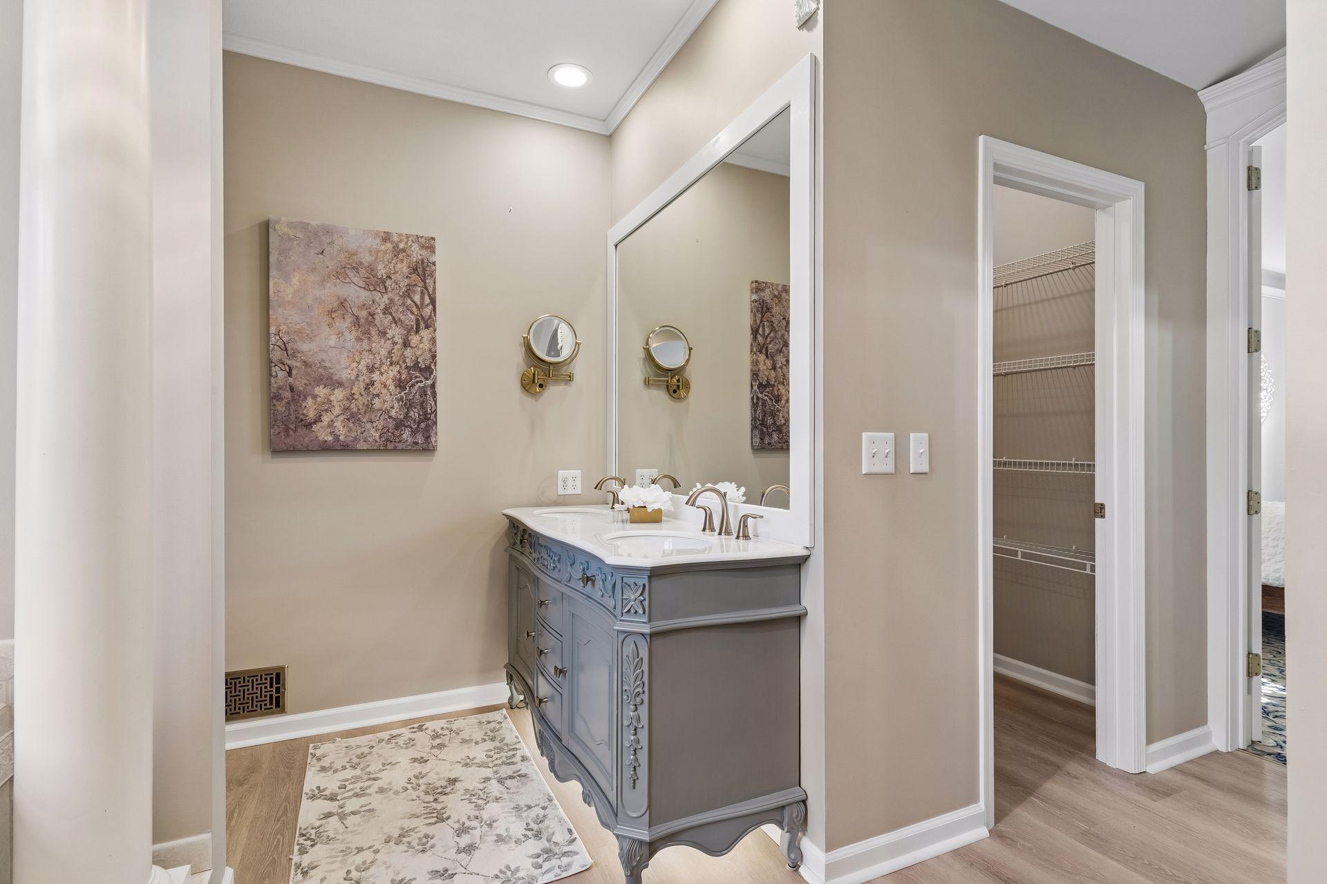 The Owner's Bath features an antique-style double vanity with Quartz countertops and has dual Walk-In Closets.