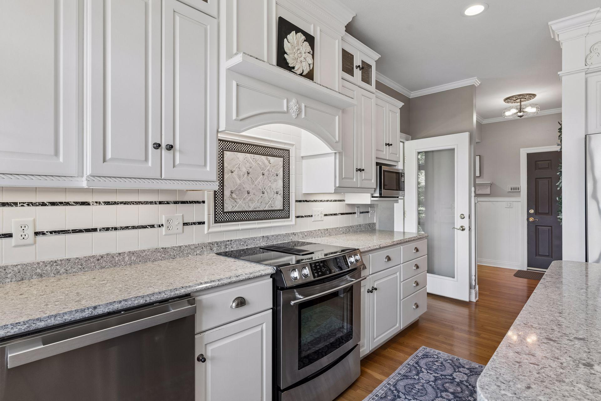 The Kitchen offers abundant cabinetry and workspace while seamlessly connecting to the Sunroom and Mud Room with extensive custom built-ins.