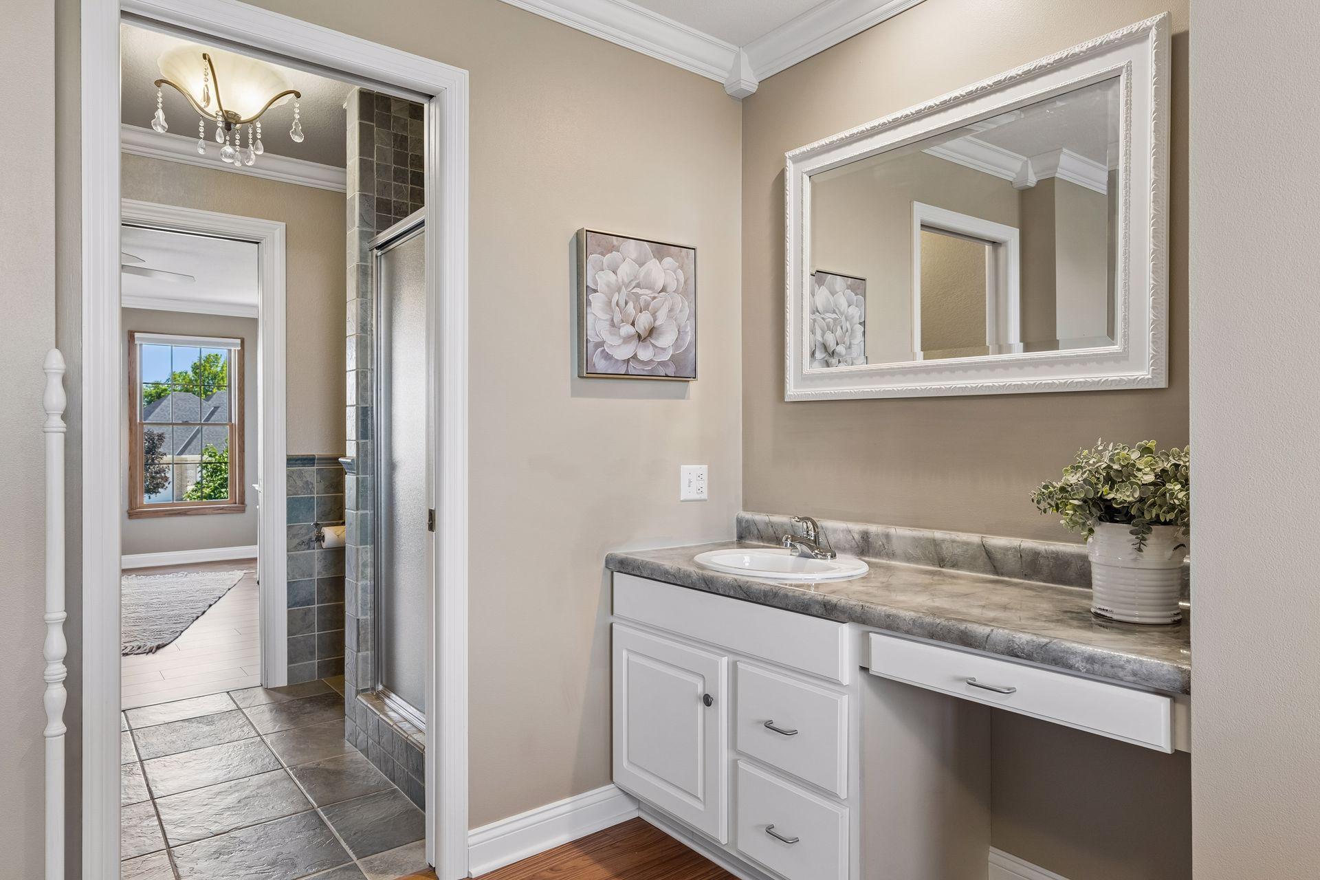 The shared Jack-and-Jill Bath has another vanity area and sink, as well as a shower.