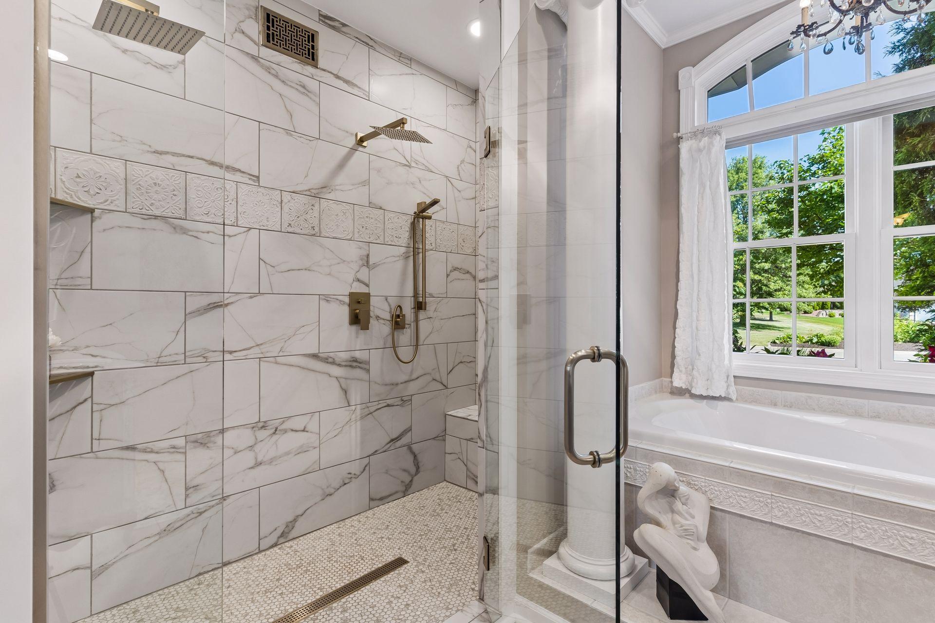 The private bath was remodeled with a luxurious walk-in tile shower to enjoy along with the separate tub.