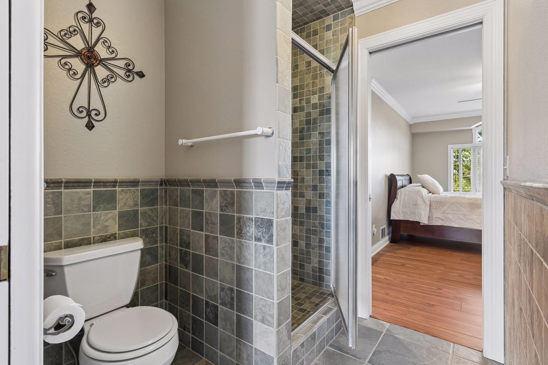 This picture shows the shared tiled shower and tile flooring.