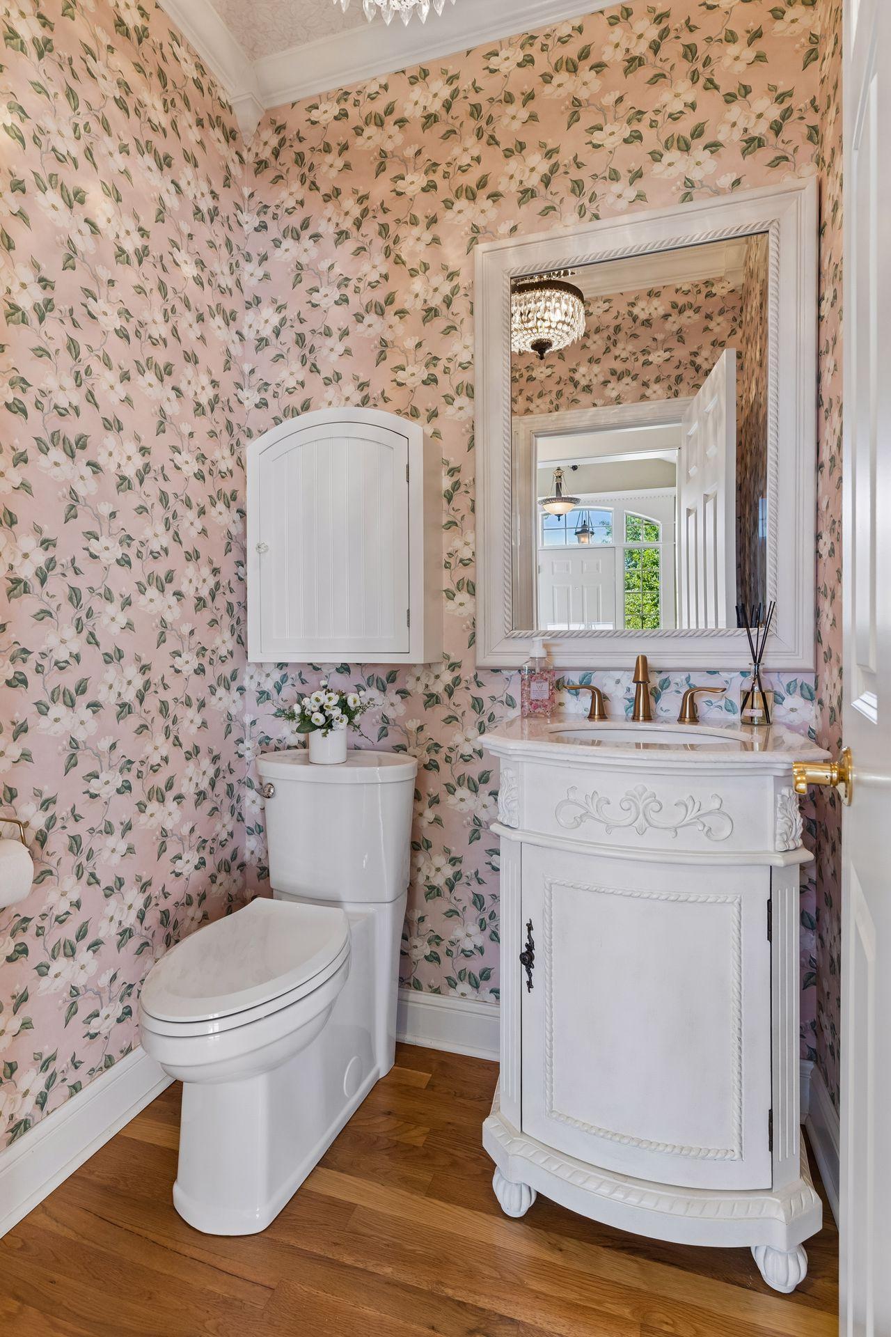 The Powder Room has an antique-style vanity, rich hardwood floors, and detailed Crown Molding.