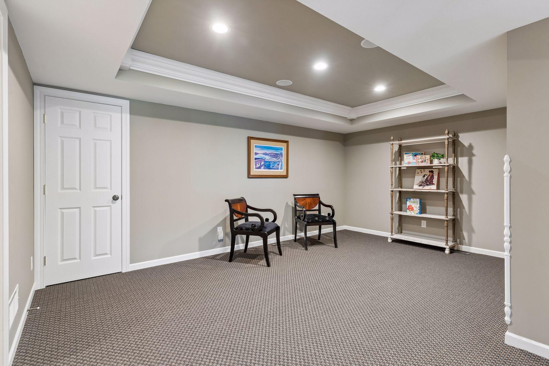 This versatile entertainment room has a tray vaulted ceiling and offers the perfect space for a pool table, media room, game nights, or additional gathering area.
