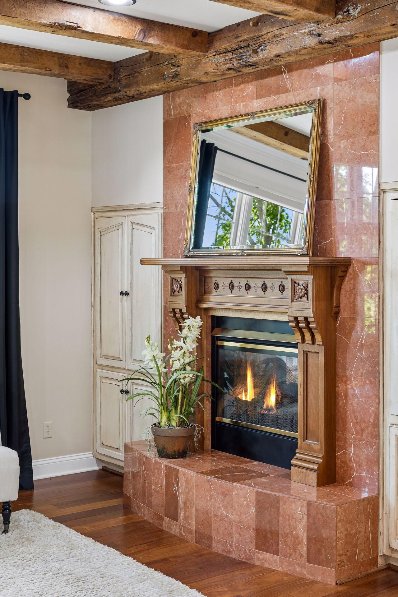 Rich Cherry hardwood floors, reclaimed wood beams from a historic barn, and a carefully selected antique mantel reclaimed from a historic home showcase the remarkable craftsmanship found throughout this home.