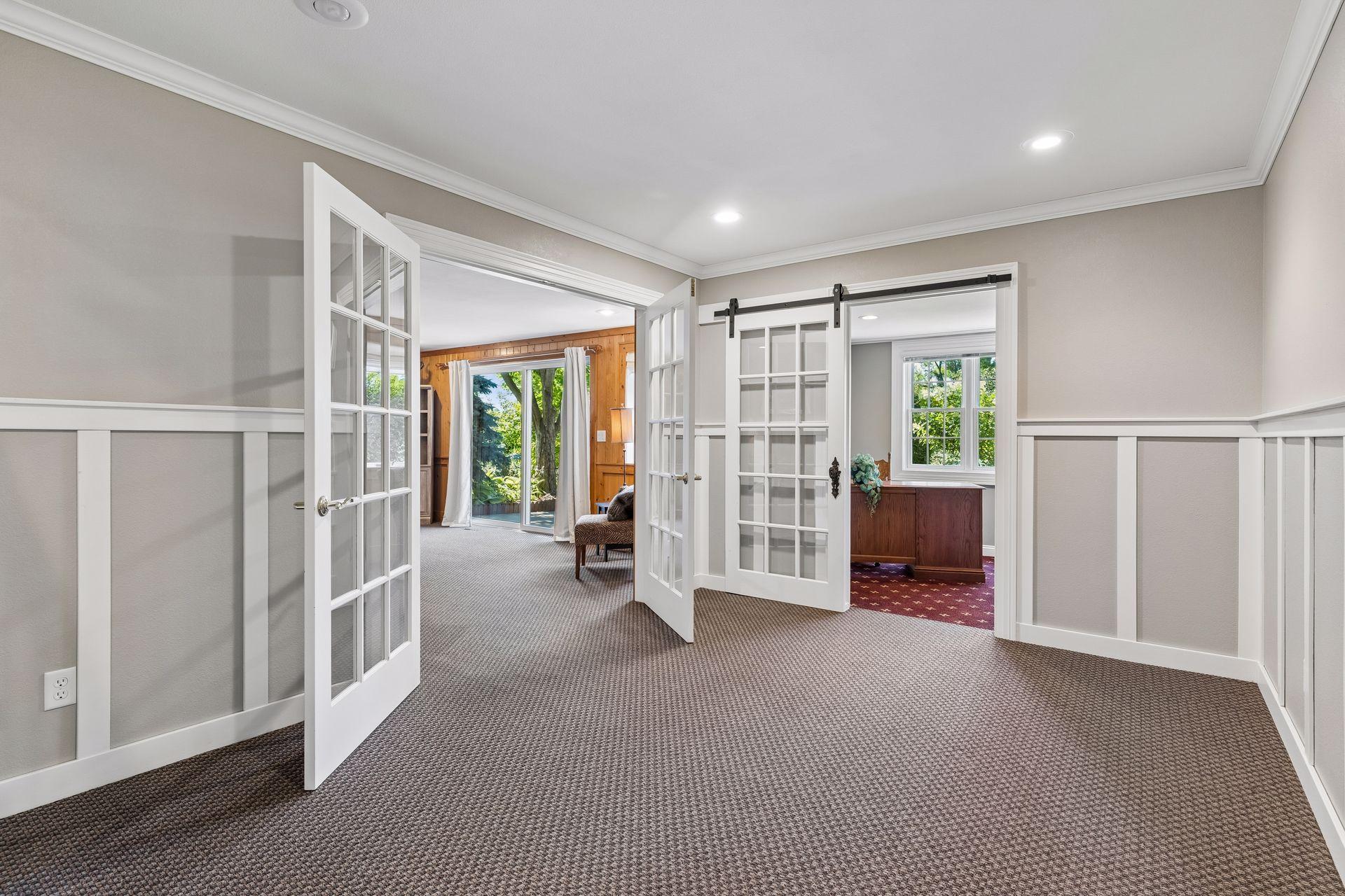 A versatile open space at the foot of the staircase creates the perfect reading nook, conversation area, or gallery space before entering the Family Room.