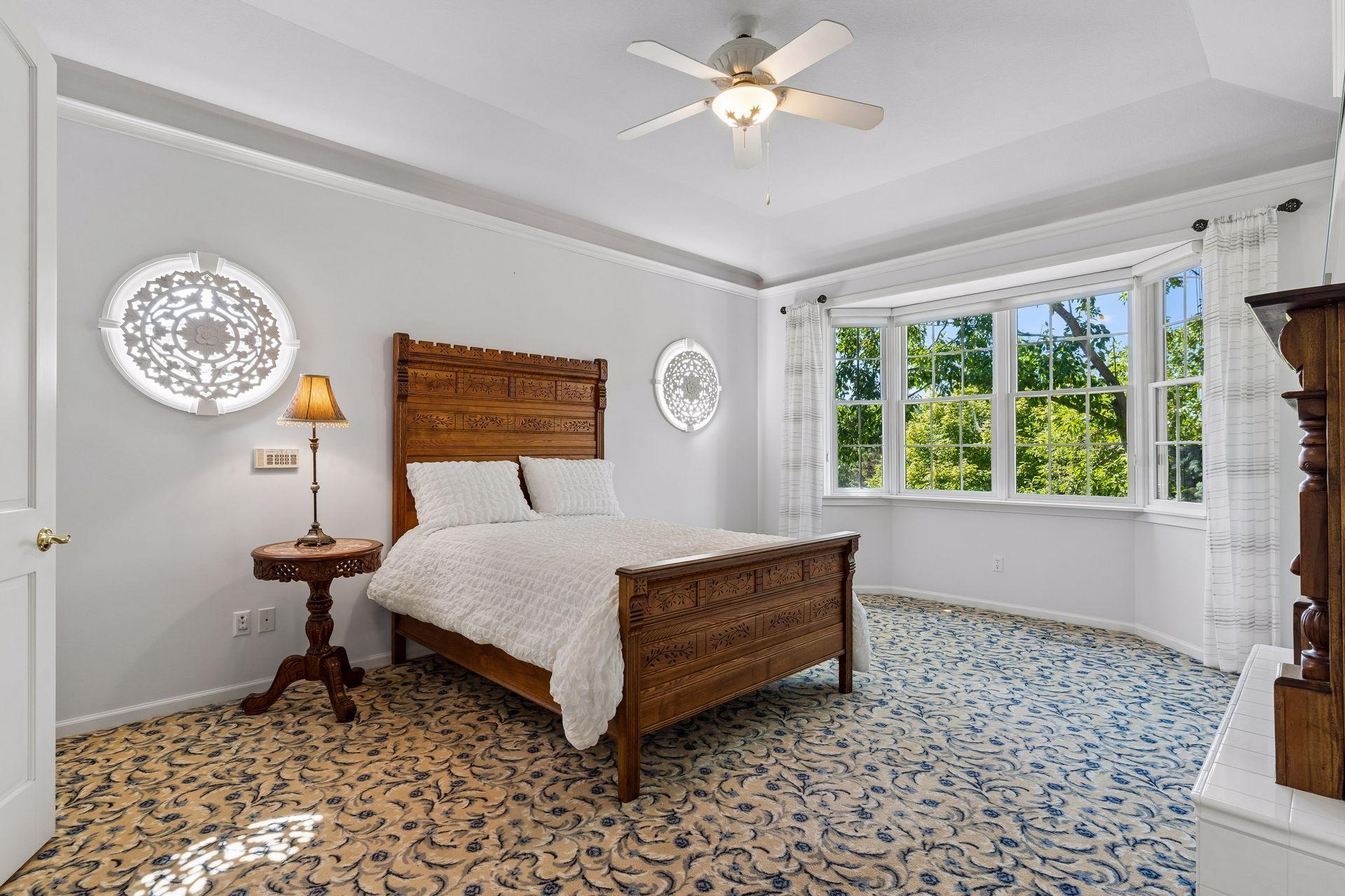 The Main Level Owner's Suite offers a true private retreat with a Gas Fireplace, bay window overlooking the yard, tray ceiling, and custom built-ins.
