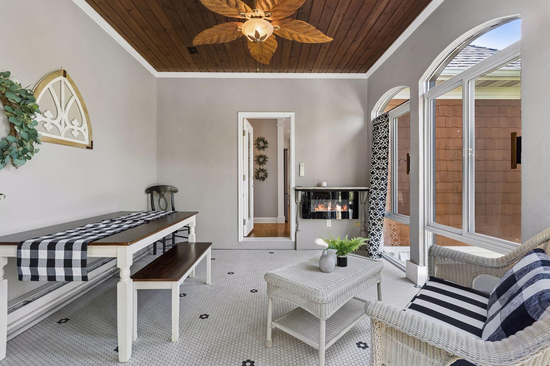 A favorite place to relax year-round, the Sunroom features a rich wood ceiling, tile floors, an electric fireplace, and its own heating and cooling while overlooking the beautifully landscaped backyard.