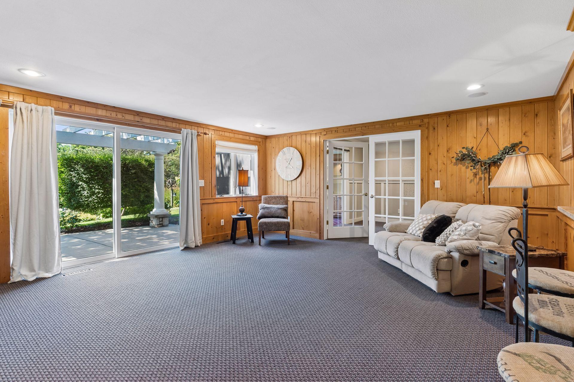 French doors open into the spacious walkout Family Room featuring a stone Gas Fireplace, and direct access to the pergola-covered patio.